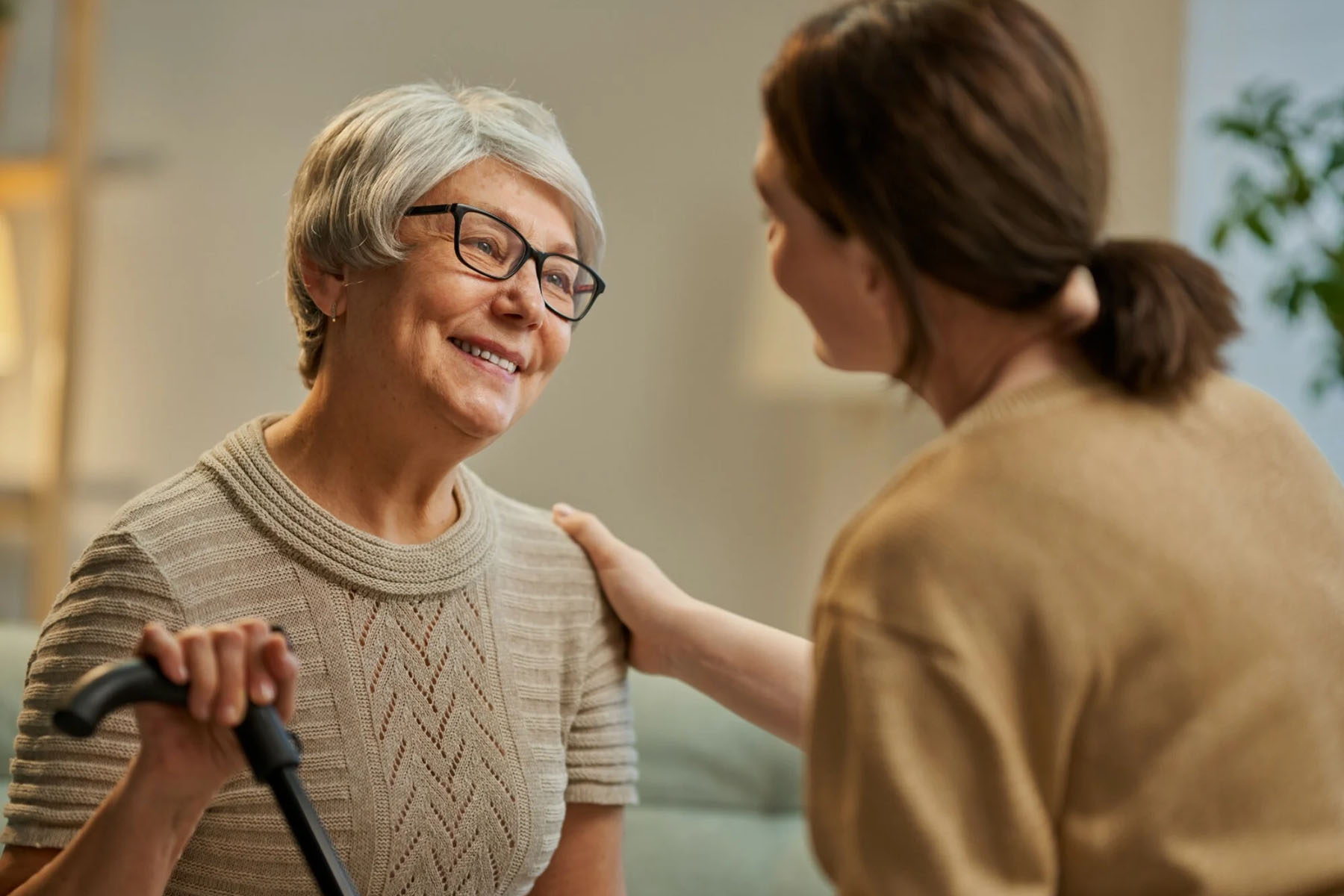 Elderly woman talking with young female carer