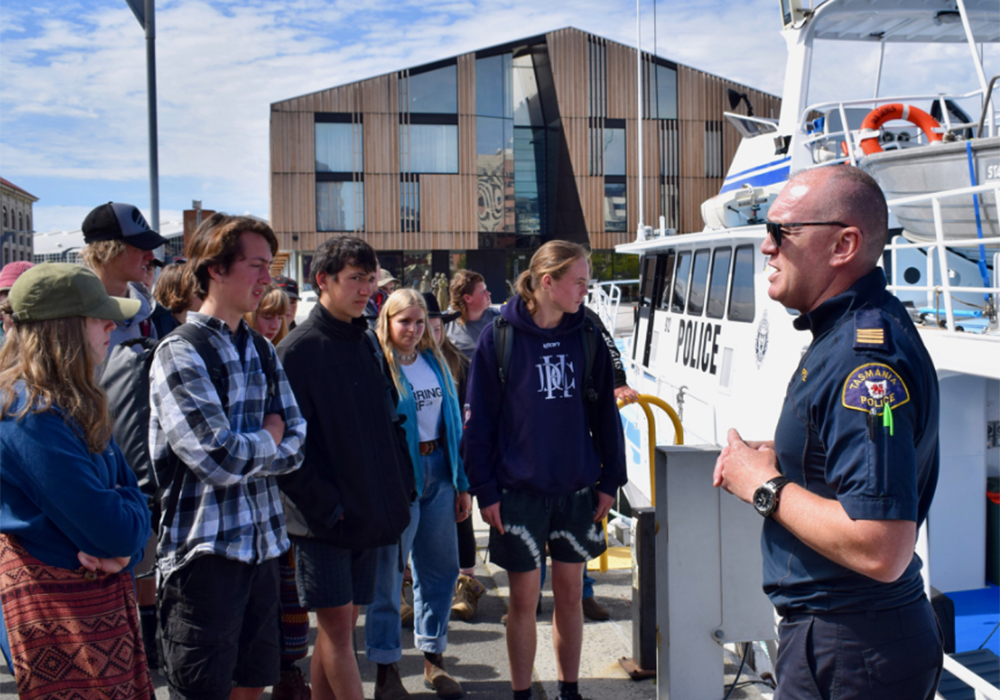 Marine police officer talking with students