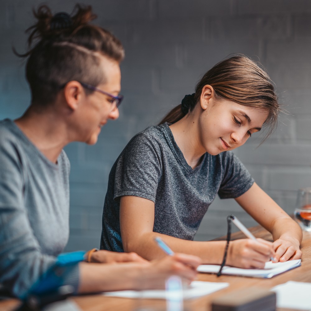 Mature woman helping daughter with study