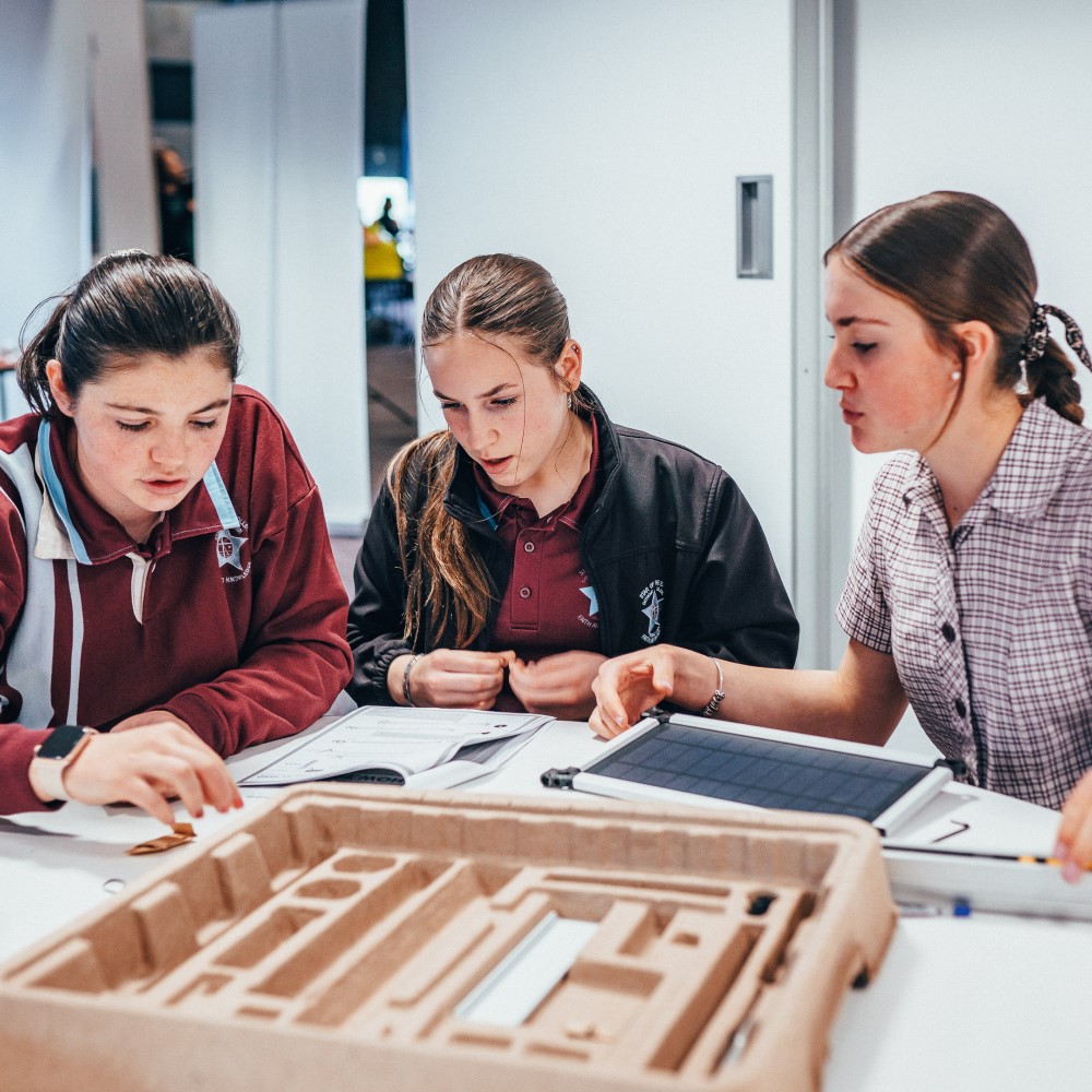 high school students building solar science experiment