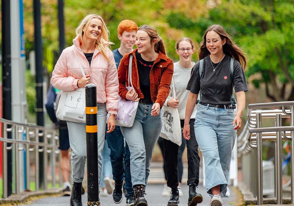 Group of young female students walking on campus