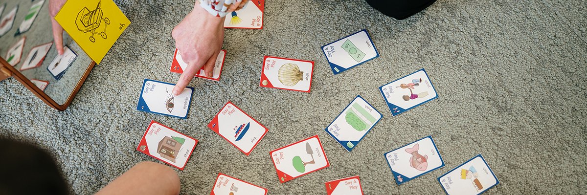 Finger pointing at speech card on the ground