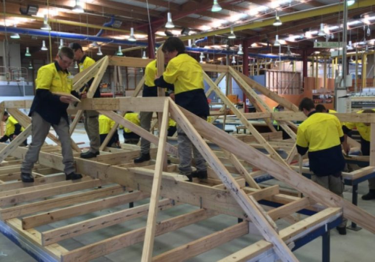 Apprentices working on housing frames