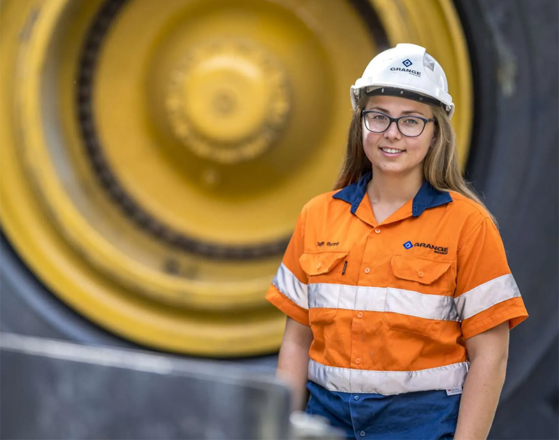 Young woman working in mining wearing helmet