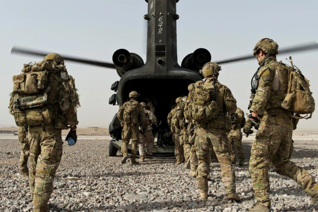 Soldiers walking onto the back of a helicopter