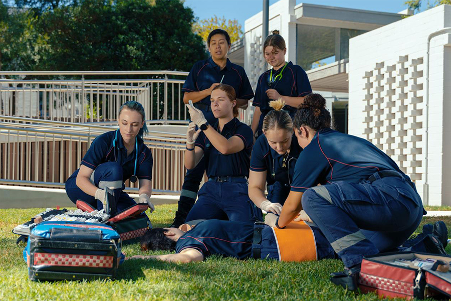 Group of paramedic students conducting a mock rescue treatment