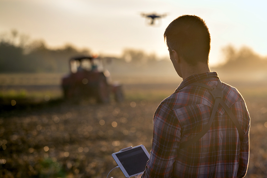 Young male farmer using drone technology