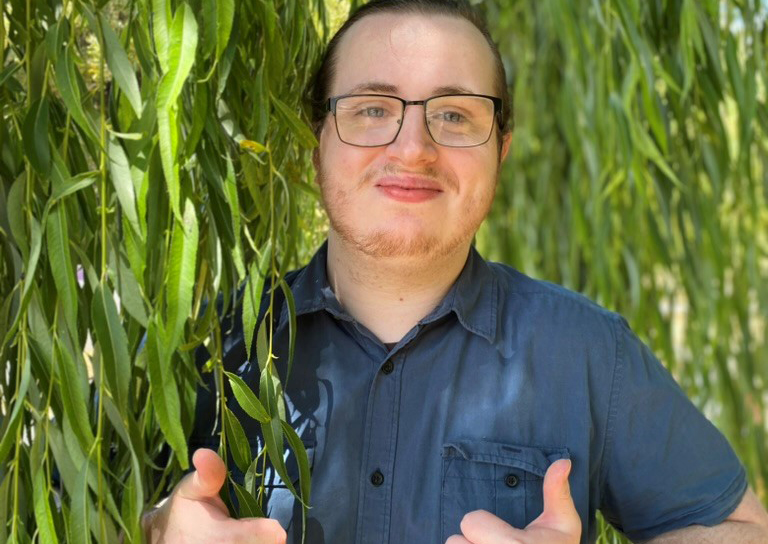 You male smiling at camera giving thumbs up