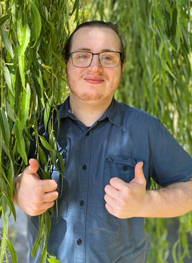 You male smiling at camera giving thumbs up