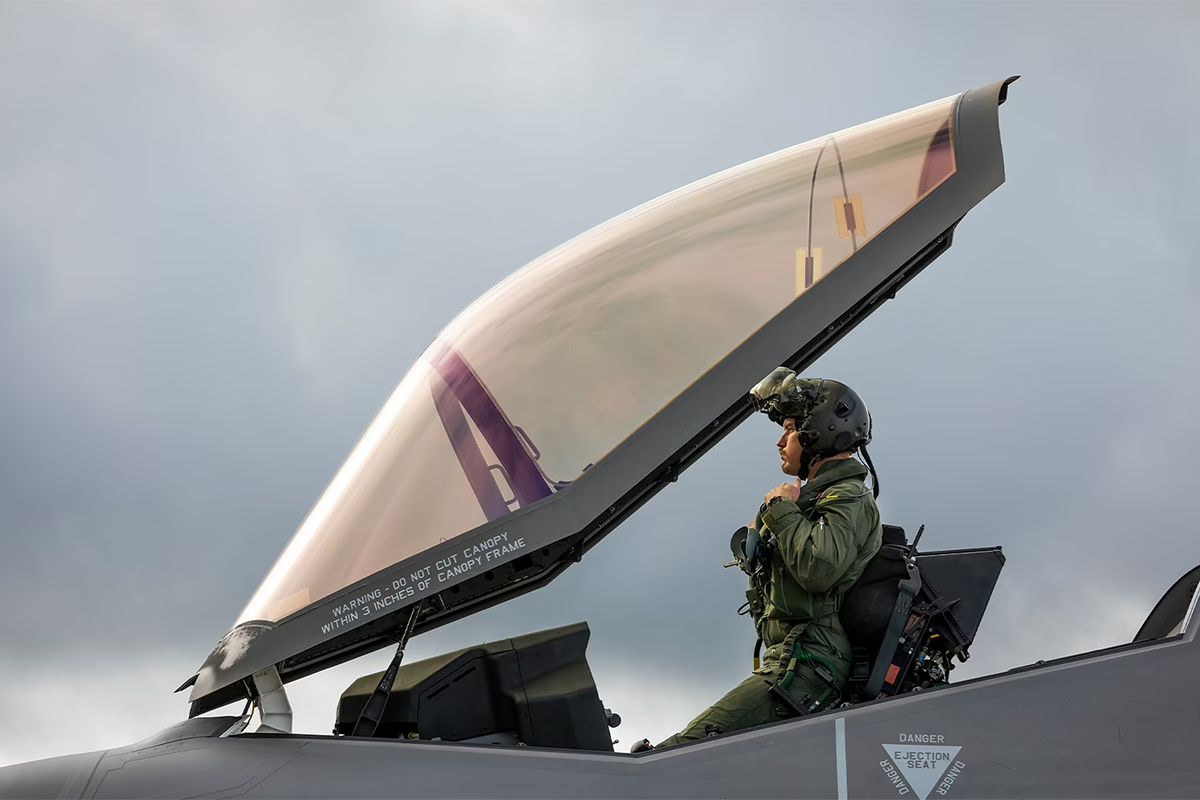 Air force pilot sitting in cockpit of plane