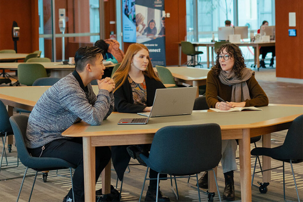 University students sitting at a table having a discussion