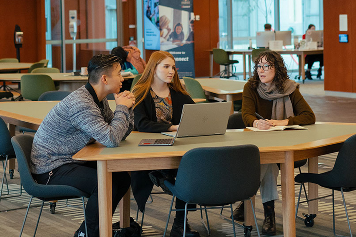 University students sitting at a table having a discussion