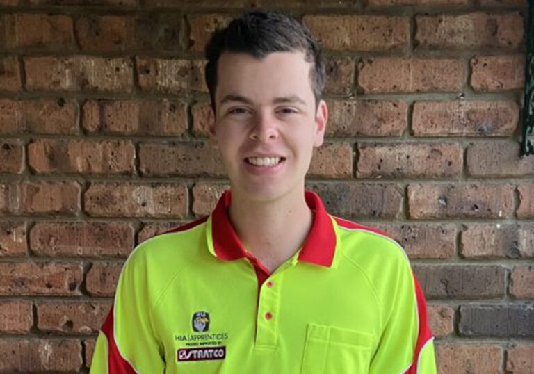 Young male apprentice smiling at the camera