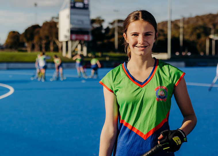 Young female sport athlete smiling at the camera