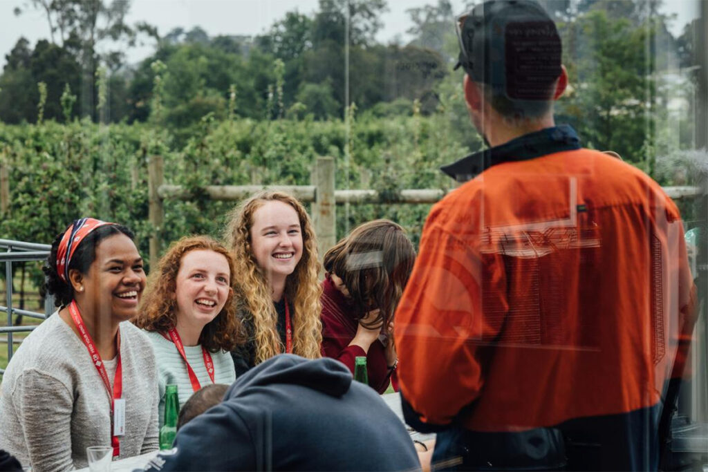 Agriculture students listening to farm worker