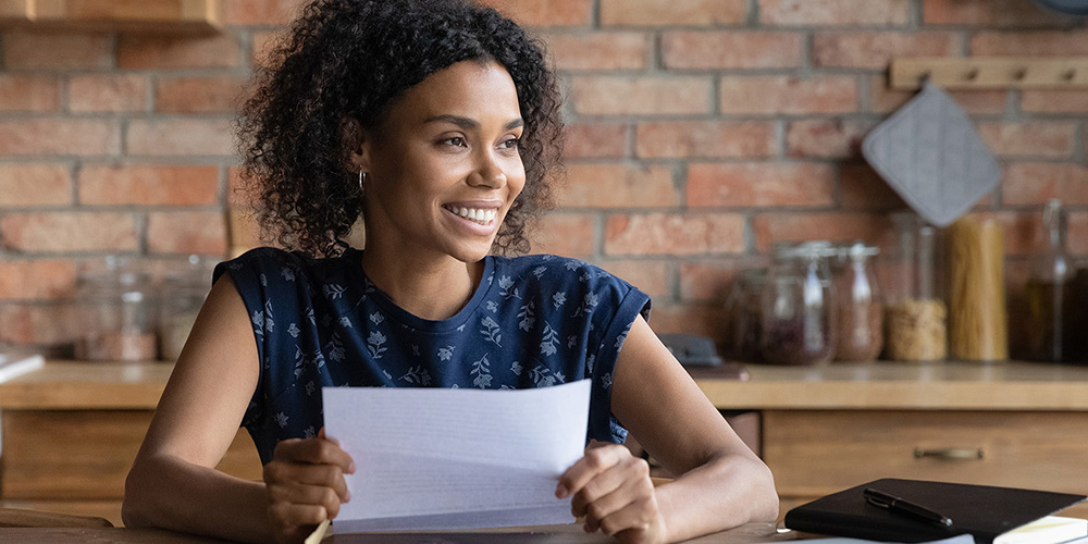 Young dark skinned woman get loan approval paper letter from bank dream of new opportunity.