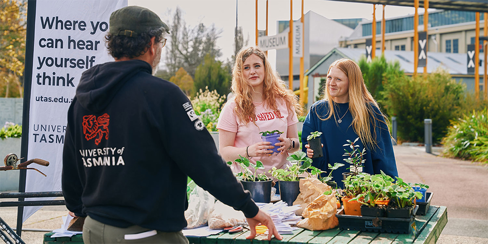 Female students meeting with a university representative at an open day